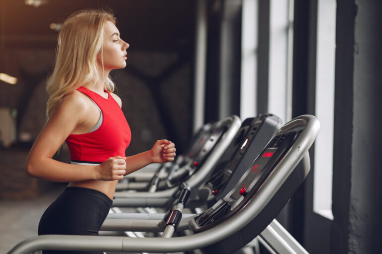 Sports blonde in a sportswear training in a gym